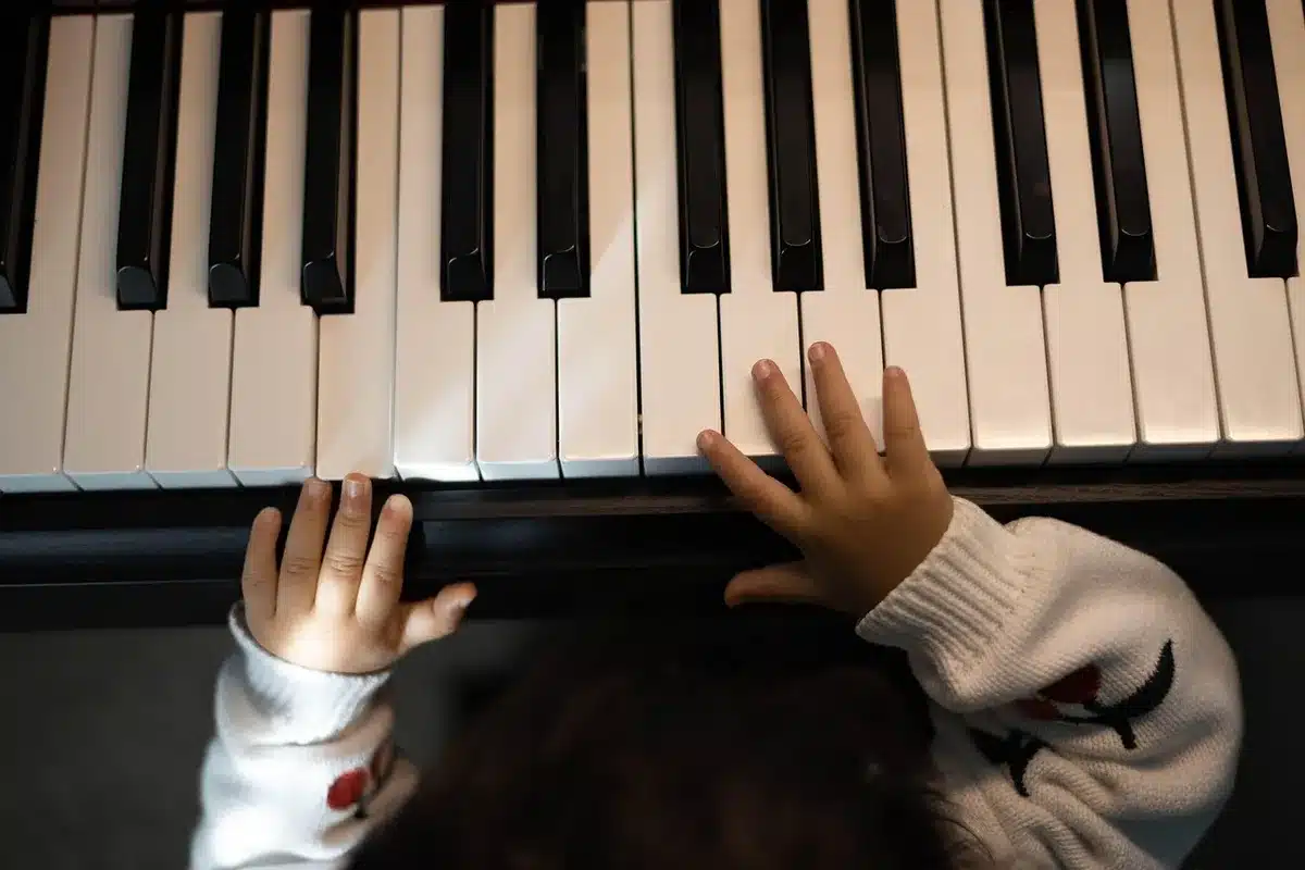 Enfant découvrant un instrument dans une atmosphère ludique et encourageante